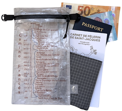 Dyneema® Valuables Holder with Camino Francés Design. Gradient and kilometers from Saint Jean Pied de Port to Santiago de Compostela.  Item is shown with pilgrim's credential, wallet, passport and money.