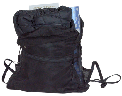Front view of the unisex MINImalist backpack. It is black in color and made of sheer nylon fabric. It is open and shows the credential, puffy coat, and Compostela tube inside.