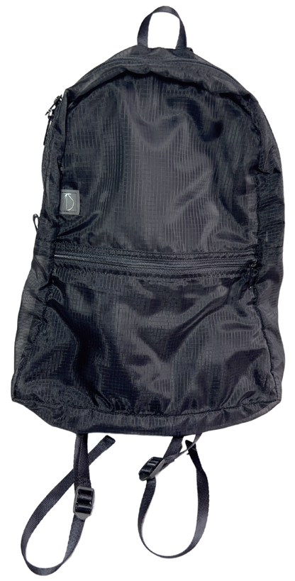 Front of the unisex MINImalist backpack. It is black in color and made of sheer nylon fabric. Backpack is empty.