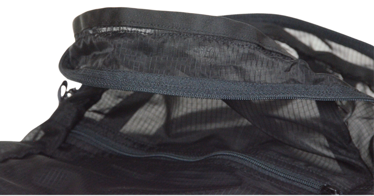 Inside detail of grosgrain and stitching of the unisex MINImalist backpack. It is black in color and made of sheer nylon fabric. Backpack is empty.