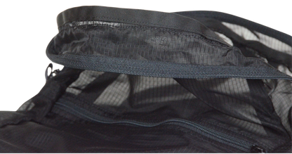 Inside detail of grosgrain and stitching of the unisex MINImalist backpack. It is black in color and made of sheer nylon fabric. Backpack is empty.