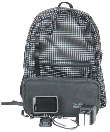 The Mighty Mini Unisex Backpack with a GoPro Camera, Case, and Batteries in front of it.