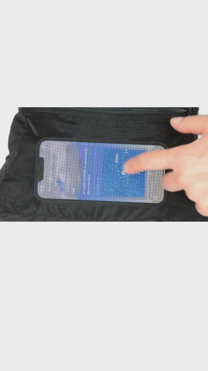Touchscreen. Front pocket of the unisex MINImalist backpack. It is black in color and made of sheer nylon fabric. Hand touches phone through fabric and scrolls on weather details in Galicia.